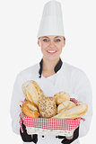Happy young chef holding bread basket