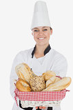Young woman in chef uniform holding bread basket