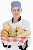 Chef with fresh breads in basket