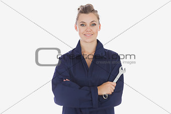 Female mechanic holding spanner