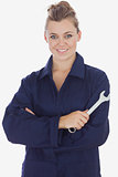 Beautiful female mechanic holding wrench