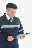 Repairman reading notes on clipboard