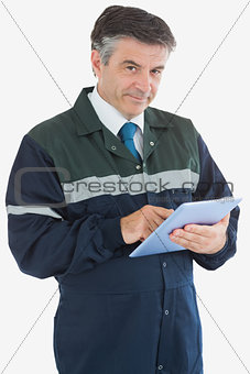 Mature repairman holding digital tablet