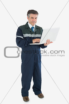 Mature repairman with laptop