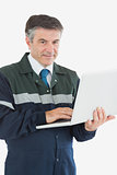 Portrait of repairman using laptop
