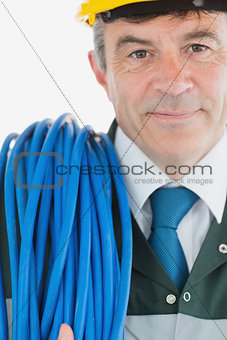 Repairman with rolled cable