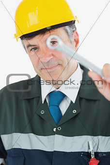 Mature repairman holding wrench