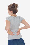 Young woman suffering from back pain