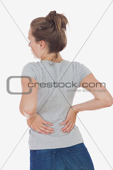 Young woman suffering from back pain
