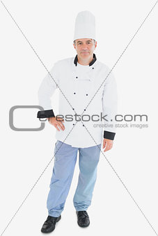 Chef in uniform standing with hand on waist
