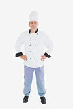Confident chef standing with arms akimbo