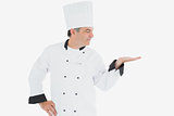 Male chef looking at invisible product