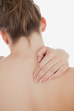 Closeup of topless woman massaging back