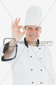Happy male chef grsturing ok