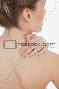 Young woman massaging back