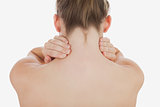 Topless woman massaging her neck