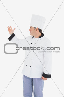 Chef displaying something on white background