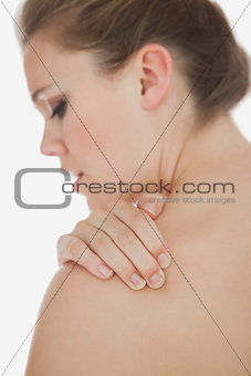 Upset woman suffering from shoulder pain