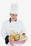 Man in chef uniform with bread basket