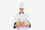 Male chef with fresh breads in basket