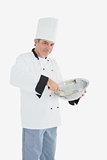 Mature chef using whisk and mixing bowl