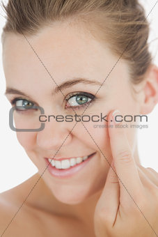 Beautiful woman touching cheek with finger