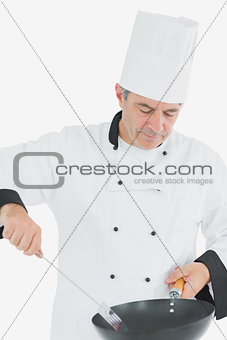 Chef using spatula and frying pan