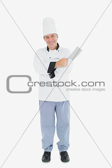 Man in chef uniform holding meat cleaver