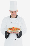 Happy chef holding pizza