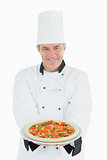 Happy chef offering pizza