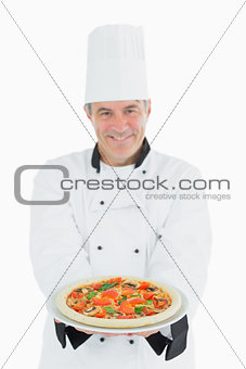 Happy chef offering pizza