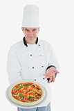 Chef displaying delicious pizza