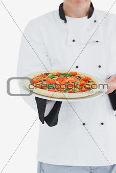 Male chef offering pizza