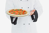 Chef offering pizza