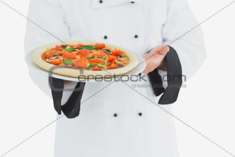 Chef offering pizza