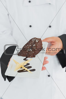 Chef offering chocolate pastry