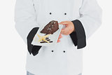 Chef offering garnished chocolate pastry