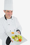 Male chef offering fresh prepared meal