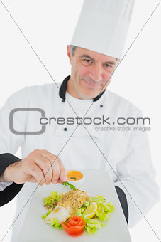 Chef garnishing prepared meal