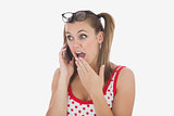 Surprised woman using cell phone