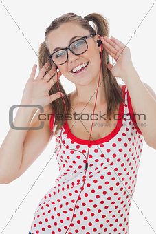 Portrait of cheerful woman listening music