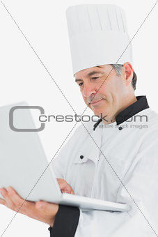 Closeup of chef using laptop