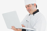 Chef using laptop smiling