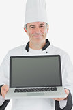 Happy male chef presenting laptop