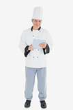 Portrait of male chef holding digital tablet
