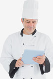 Male chef using tablet pc