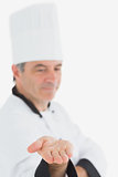 Male chef displaying an invisible product