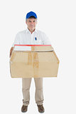 Mature courier man carrying package