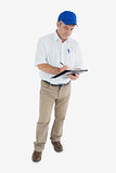 Delivery man signing paper on clipboard