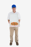 Mature delivery man looking at fresh pizza